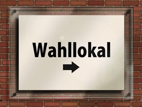 Schild mit Pfeil in Richtung Wahllokal